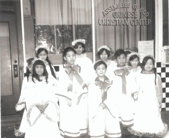 A group of young girls wearing white dresses

Description automatically generated